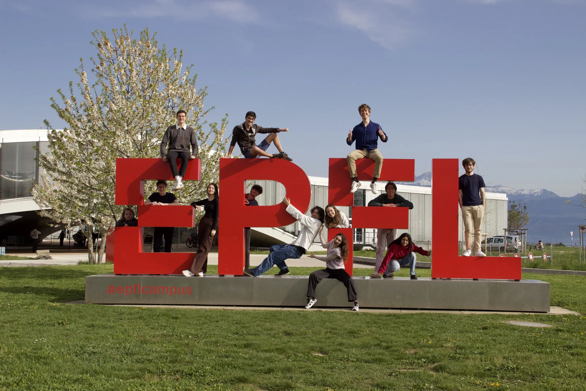 Carbon Team members posing on the EPFL sign on campus